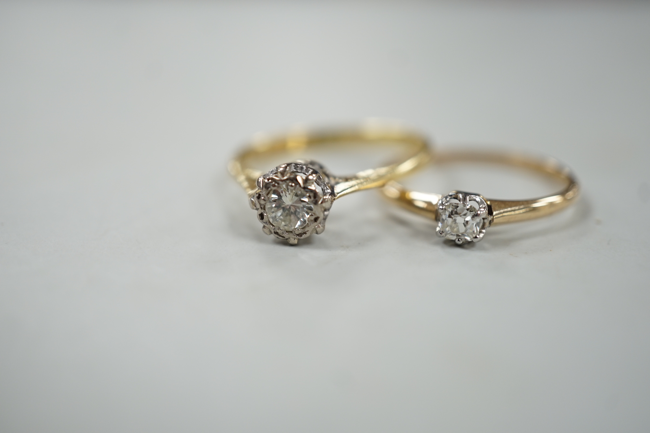 A modern 18ct gold and illusion set solitaire diamond ring, size N and one other smaller 18ct and solitaire diamond ring, gross weight 3.7 grams.